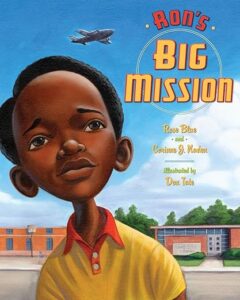 Cover art of ‘Ron’s Big Mission’ depicting young Ron McNair sitting on a library floor with books, challenging segregation.